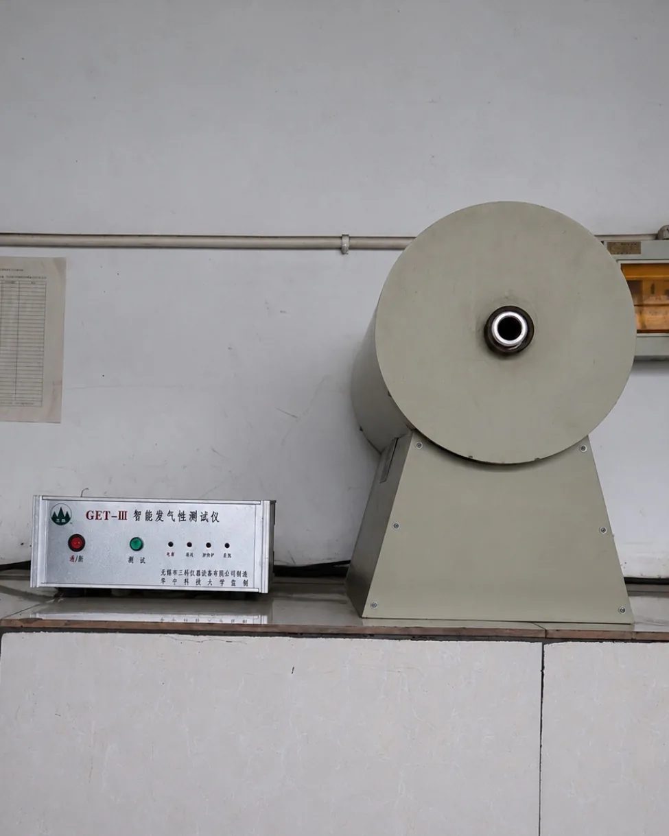 Gas generation tester for evaluating outgassing behaviour of resin-coated sand in foundry process control.