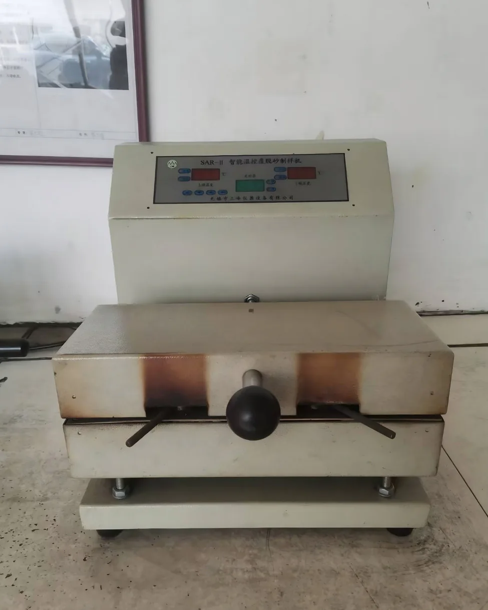 Resin-coated sand sample maker for controlled-temperature shell specimens used in mould quality testing.